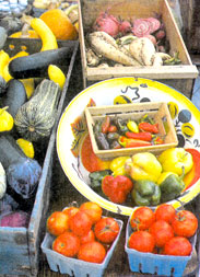 Tomatoes and squash for sale at the farmers' market.